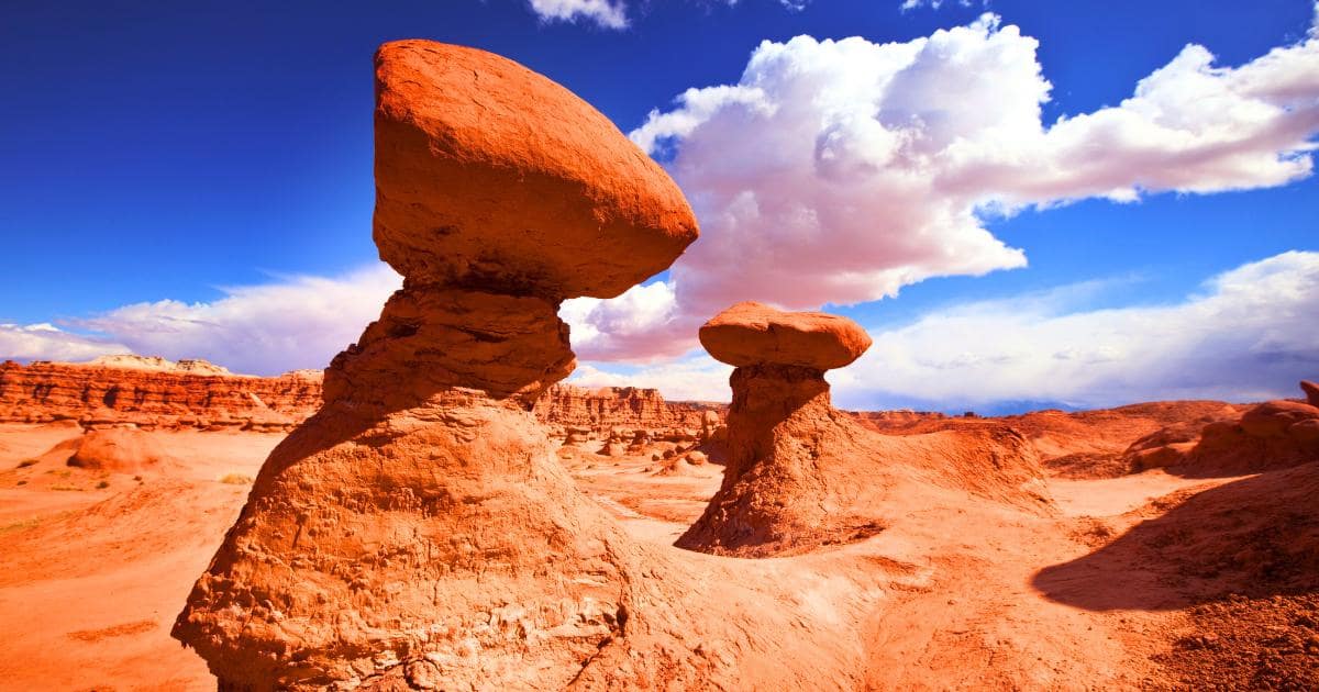 red stone rock formations, blue sky with clouds